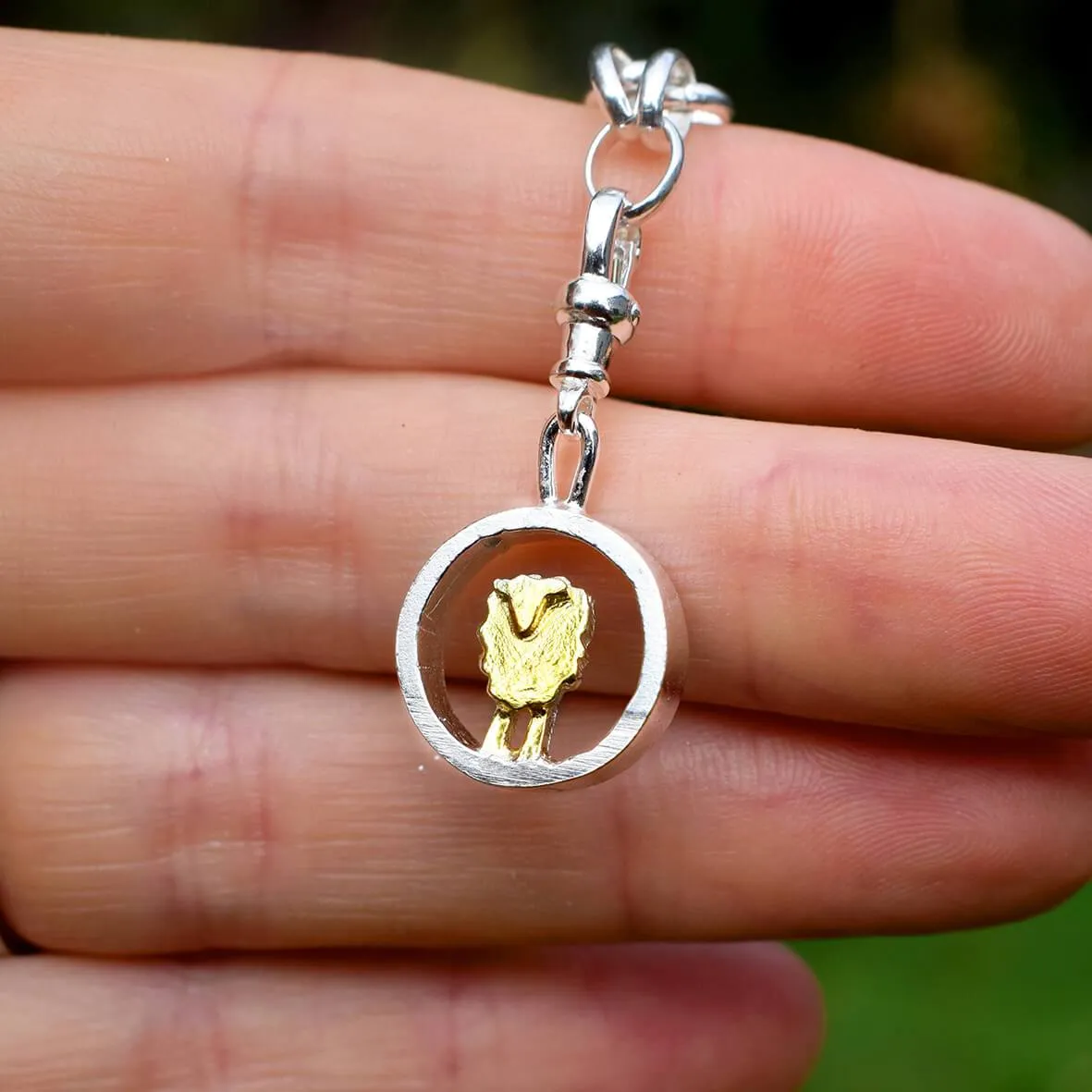 Gold and silver circle sheep charm