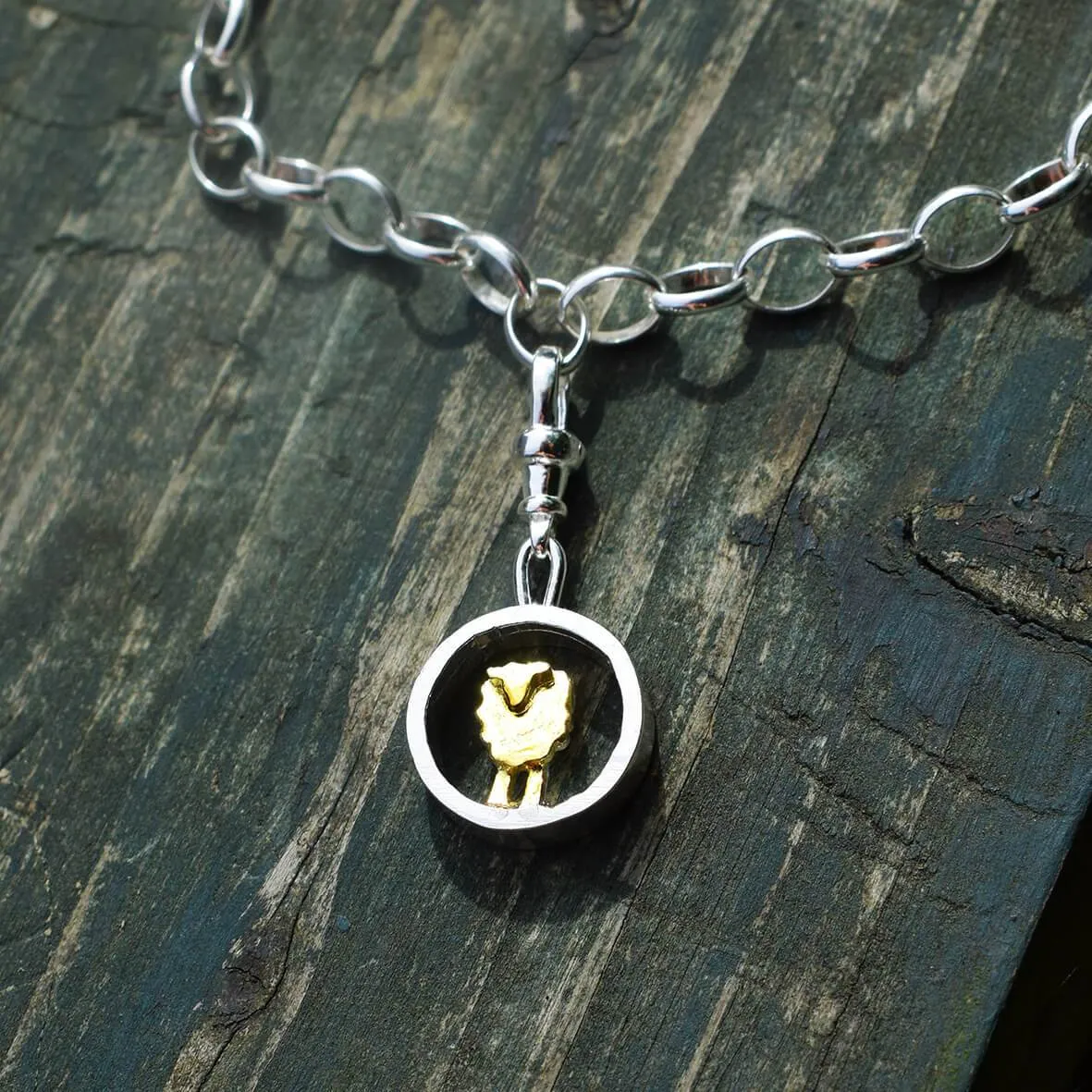 Gold and silver circle sheep charm