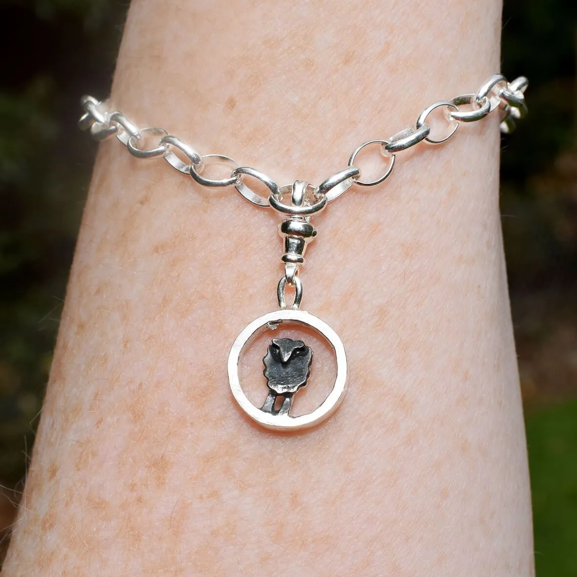 Silver circle black sheep charm